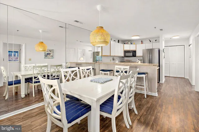 a view of a dining room with furniture and wooden floor