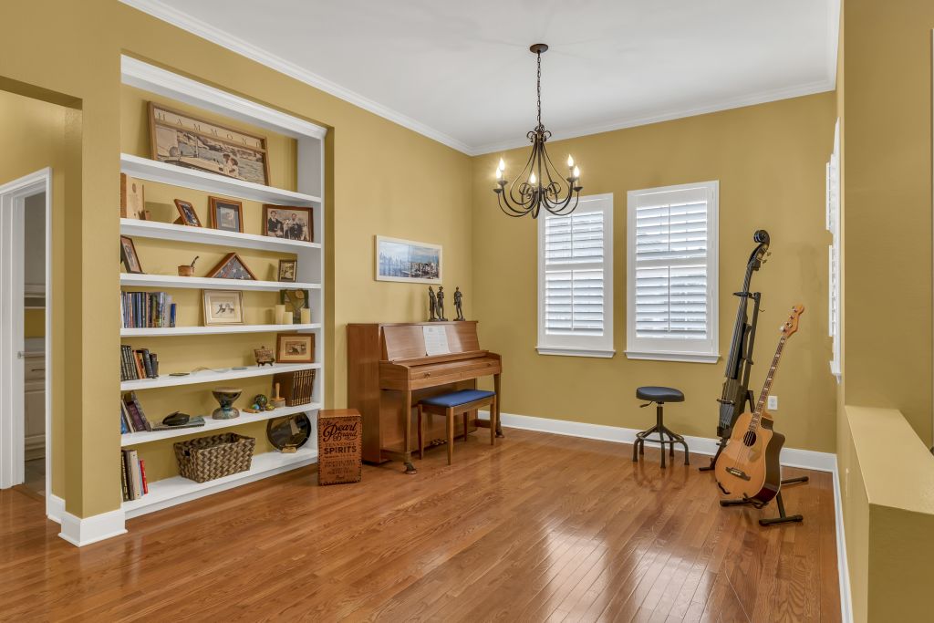 144 Cattle Trail Way Georgetown, TX 78633 - Photo 5 of 37 Hardwood floors and built-in shelving create a warm and inviting living space.