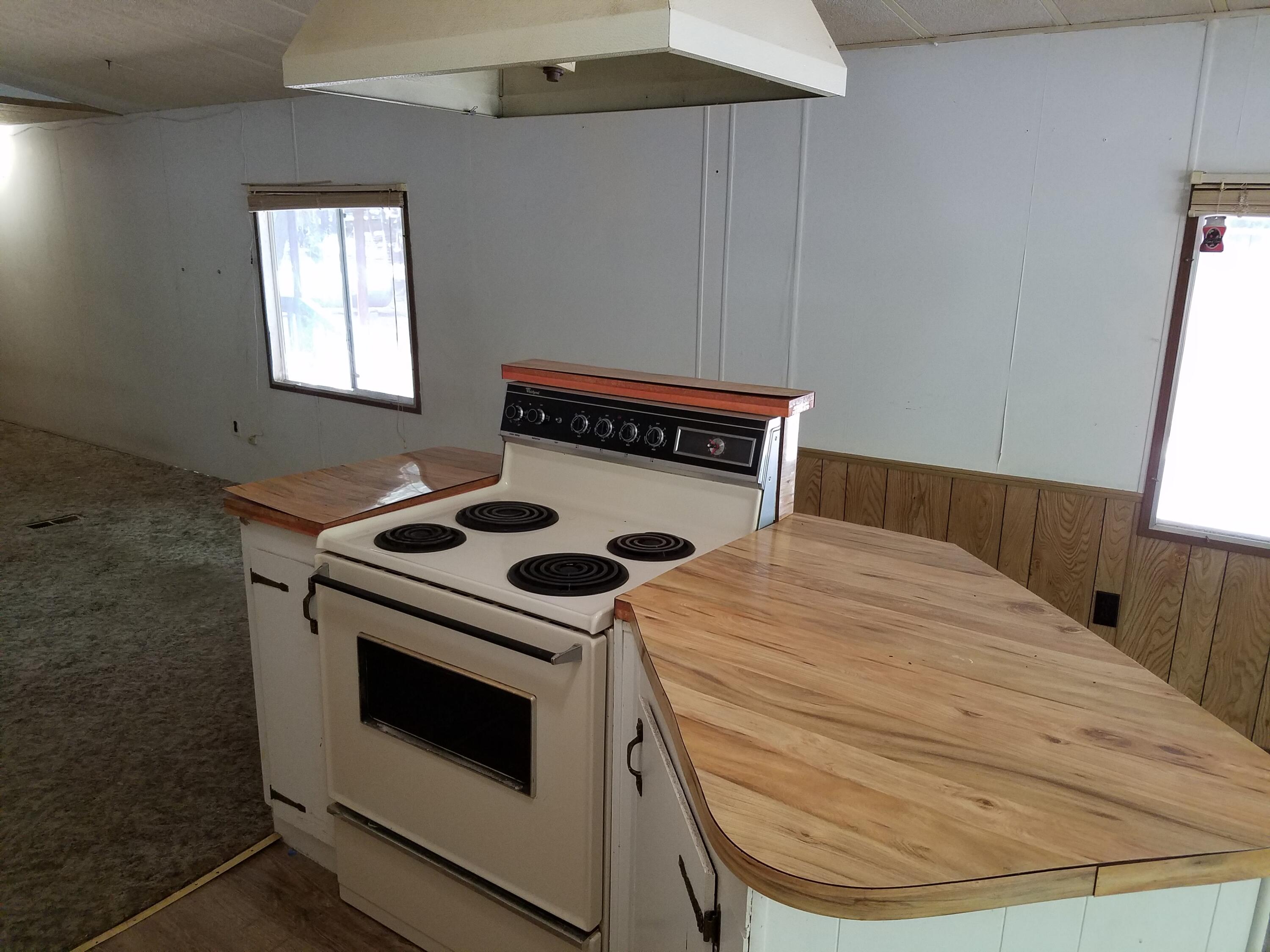 9340 Thatcher Mill Road Shingletown, CA 96088 - Photo 11 of 32 a kitchen with a stove and a window