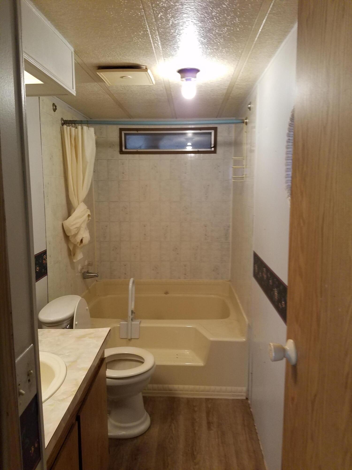 9340 Thatcher Mill Road Shingletown, CA 96088 - Photo 17 of 32 a bathroom with a granite countertop sink toilet and shower