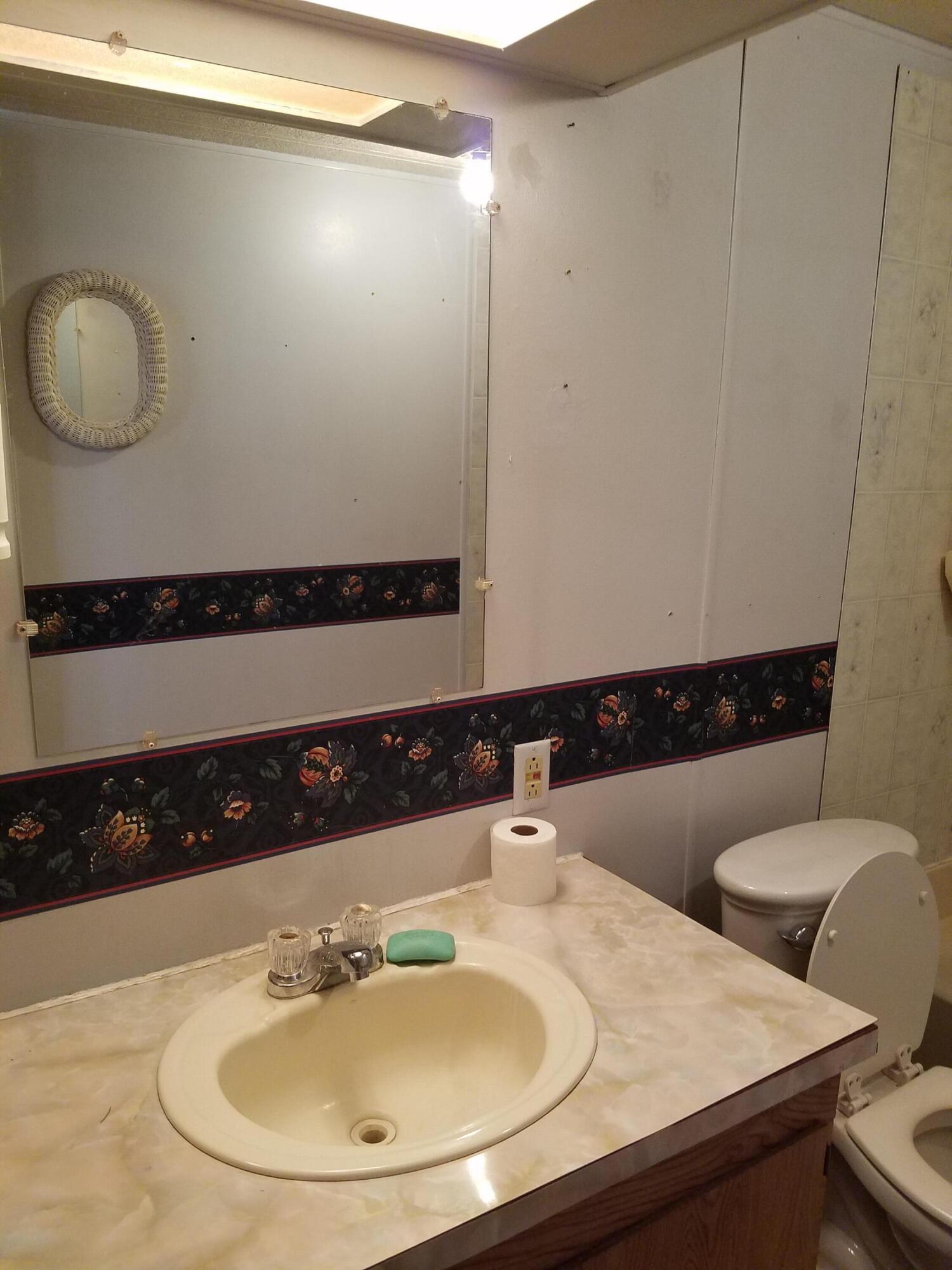 9340 Thatcher Mill Road Shingletown, CA 96088 - Photo 18 of 32 a bathroom with a sink and a mirror