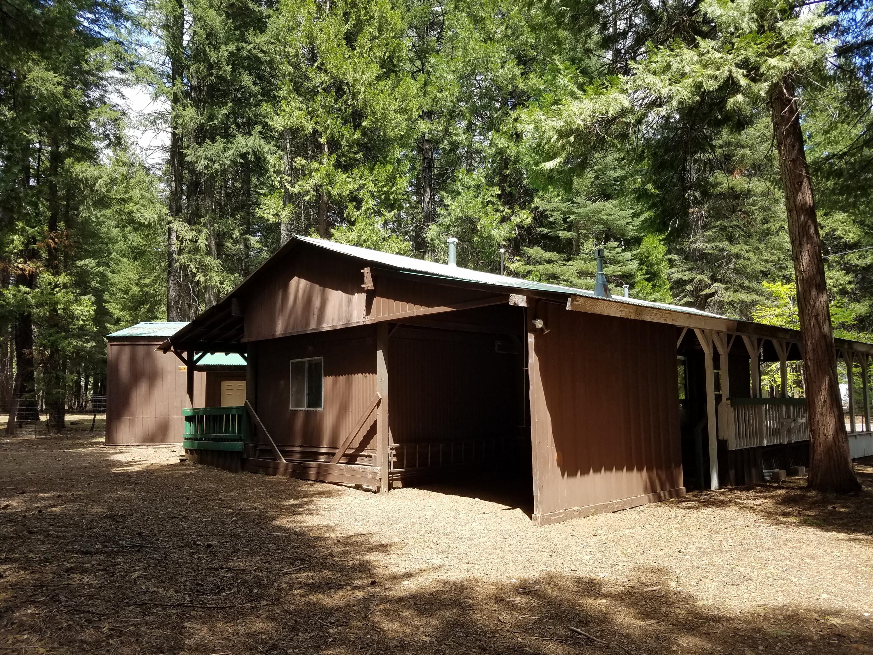 9340 Thatcher Mill Road Shingletown, CA 96088 - Photo 26 of 32 a backyard of a house with wooden fence and deck