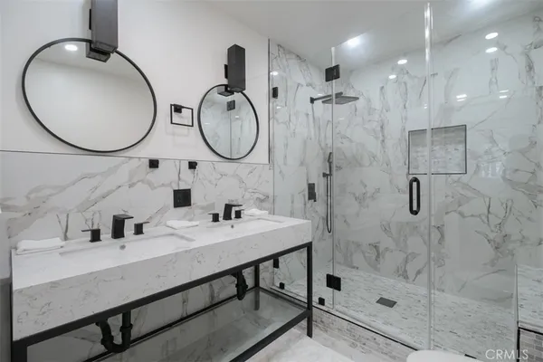 a bathroom with a sink double vanity and a mirror