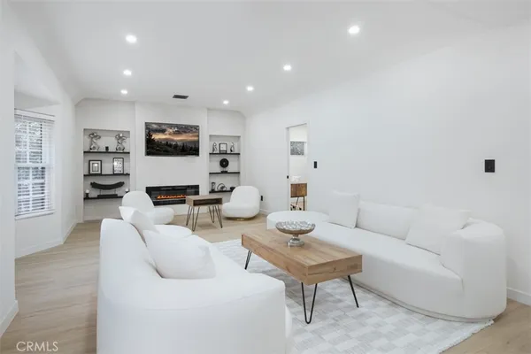 a living room with furniture a rug and a flat screen tv