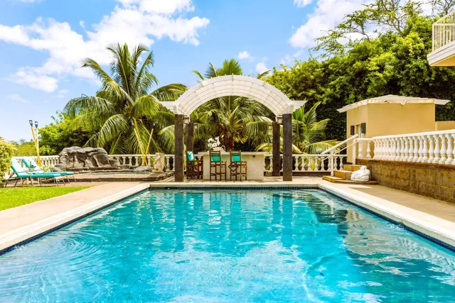 a large white kitchen with a large window