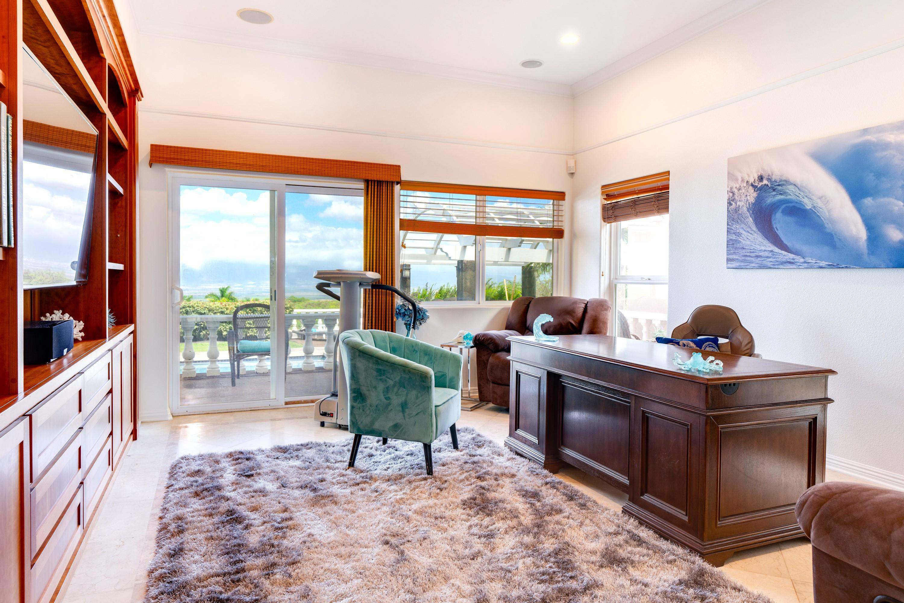 3446 Omaopio Road Kula, HI 96790 - Photo 33 of 49 a living room with furniture and a gate
