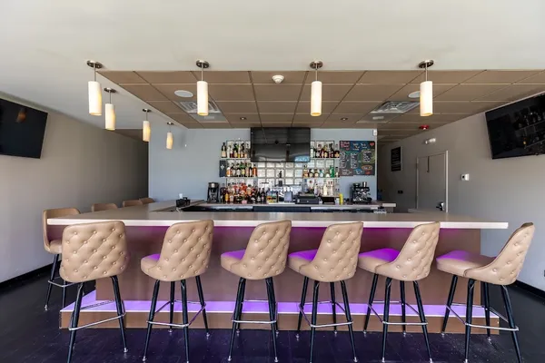 a kitchen with stainless steel appliances kitchen island granite countertop a dining table and chairs with wooden floor