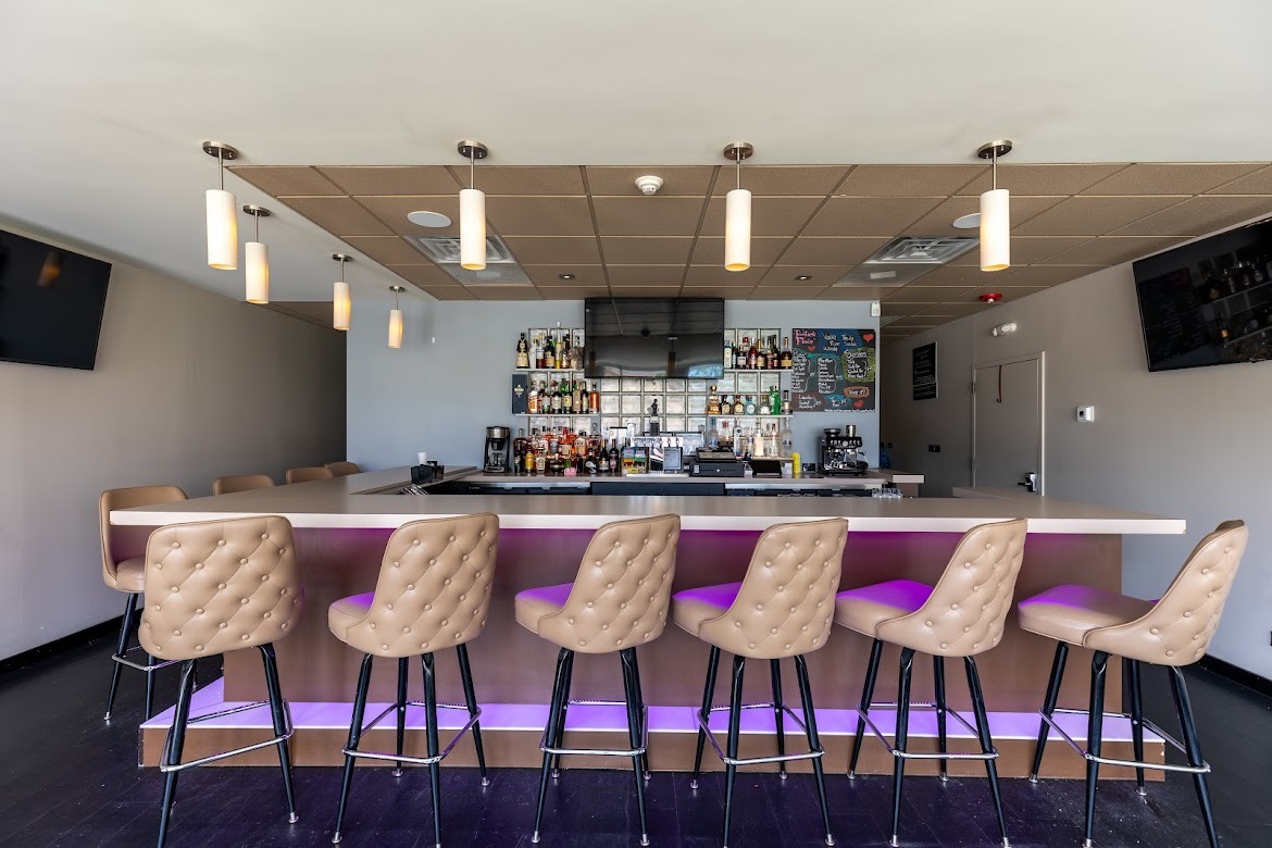 8905 Cermak Road North Riverside, IL 60546 - Photo 4 of 14 a kitchen with stainless steel appliances kitchen island granite countertop a dining table and chairs with wooden floor
