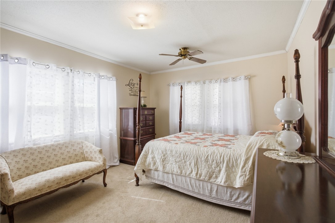 108 Hodge Street Abbeville, SC 29620 - Photo 21 of 39 A comforting bedroom with warm neutral walls and sun-filled windows, perfect for serene mornings.
