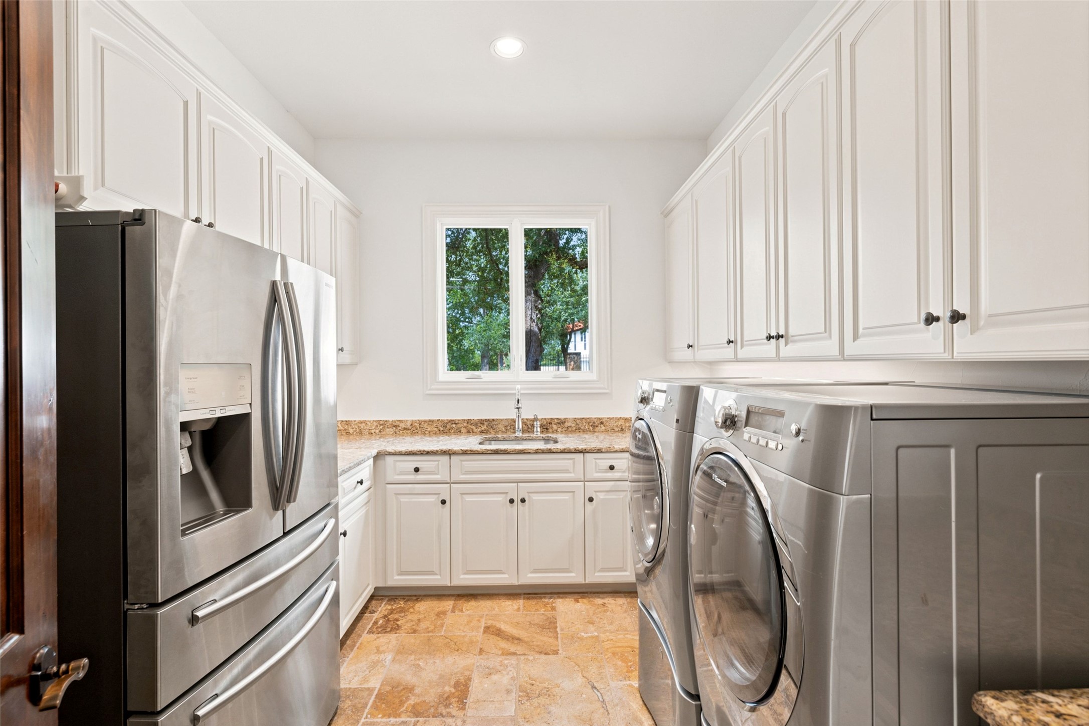 1414 The High Road Austin, TX 78746 - Photo 28 of 40 Practical laundry area with abundant cabinetry and elegant tile flooring.