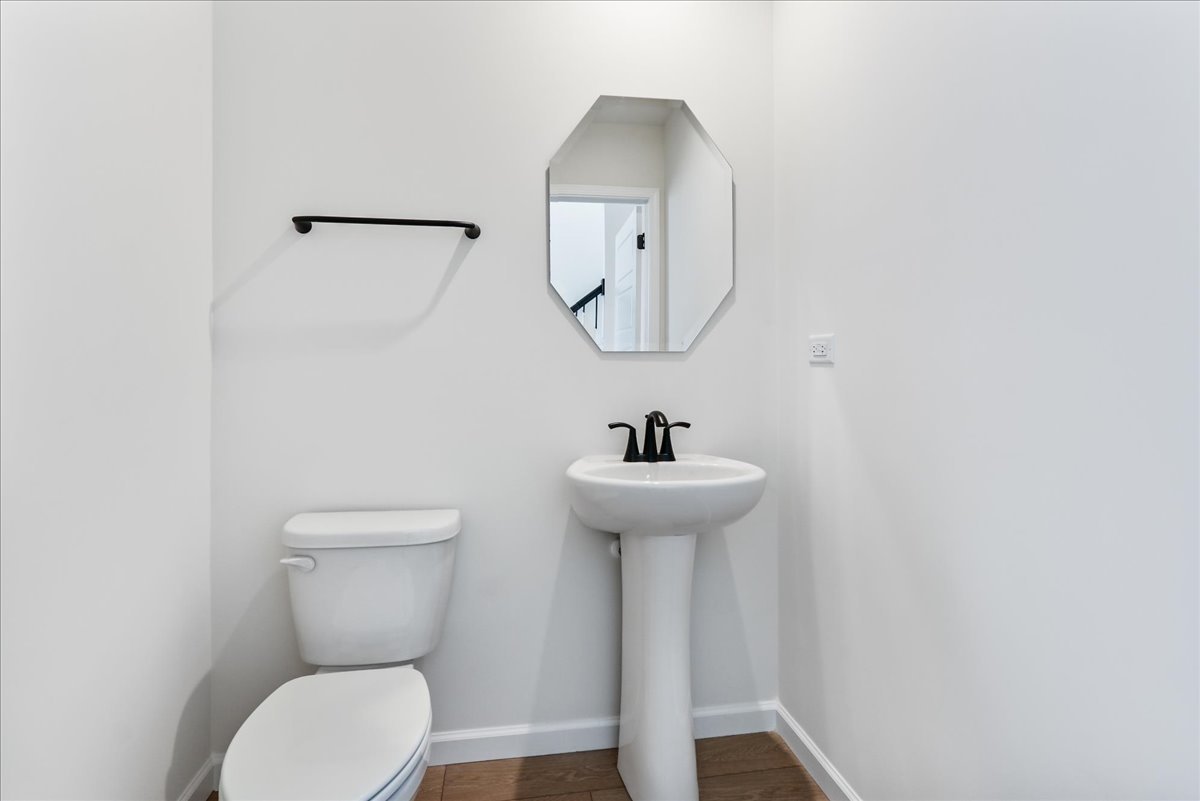 667 Switchgrass Way, Unit 62003 Bolingbrook, IL 60490 - Photo 19 of 33 a bathroom with a toilet sink and mirror