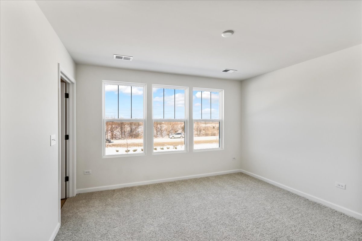 667 Switchgrass Way, Unit 62003 Bolingbrook, IL 60490 - Photo 21 of 33 a view of an empty room with a window