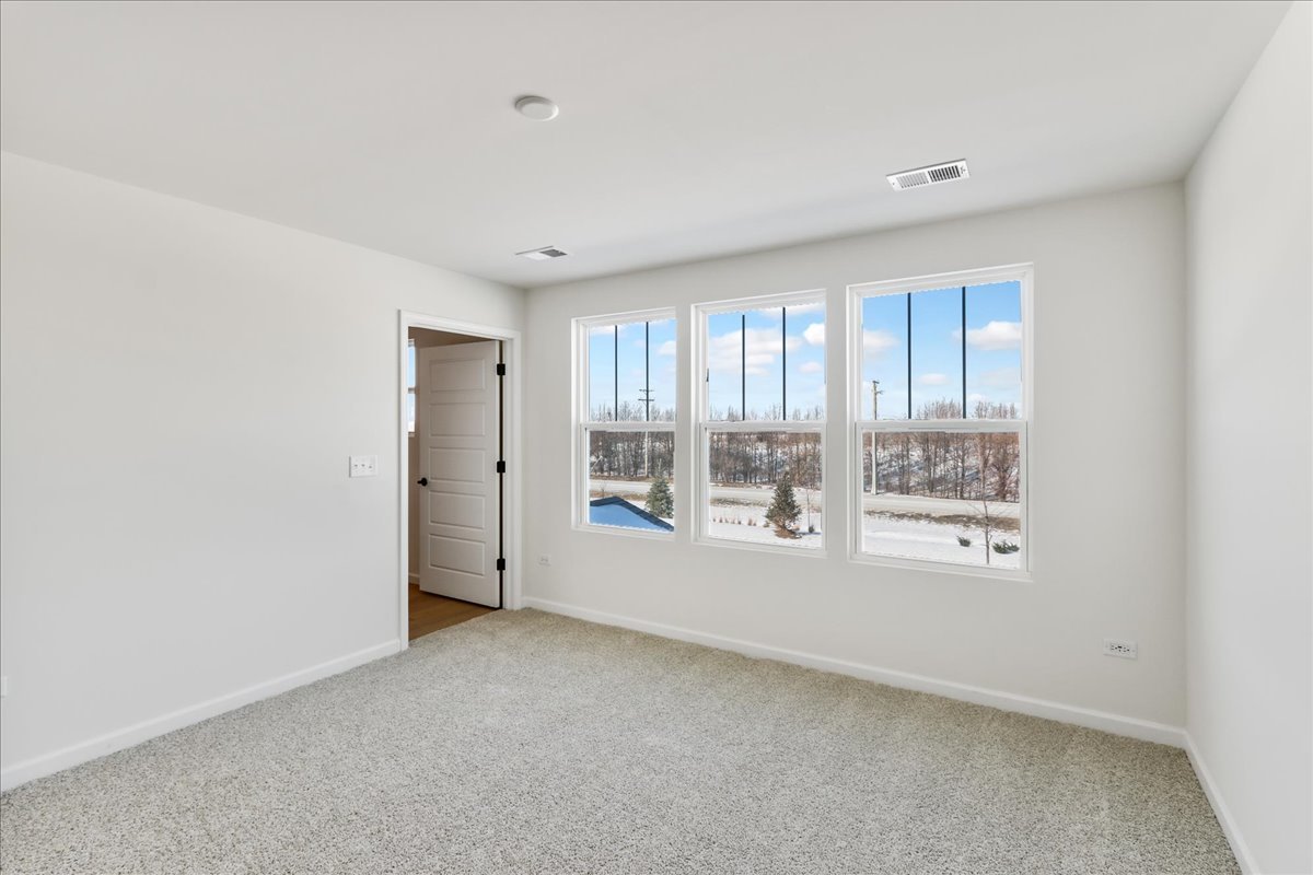 667 Switchgrass Way, Unit 62003 Bolingbrook, IL 60490 - Photo 22 of 33 a view of an empty room with a window