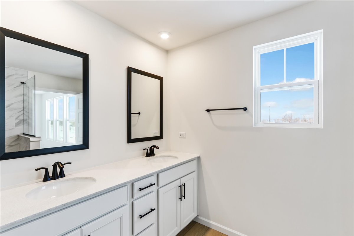 667 Switchgrass Way, Unit 62003 Bolingbrook, IL 60490 - Photo 23 of 33 a bathroom with 2 sink and a mirror
