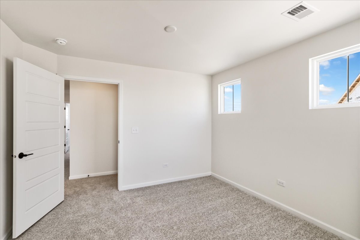 667 Switchgrass Way, Unit 62003 Bolingbrook, IL 60490 - Photo 27 of 33 a view of an empty room