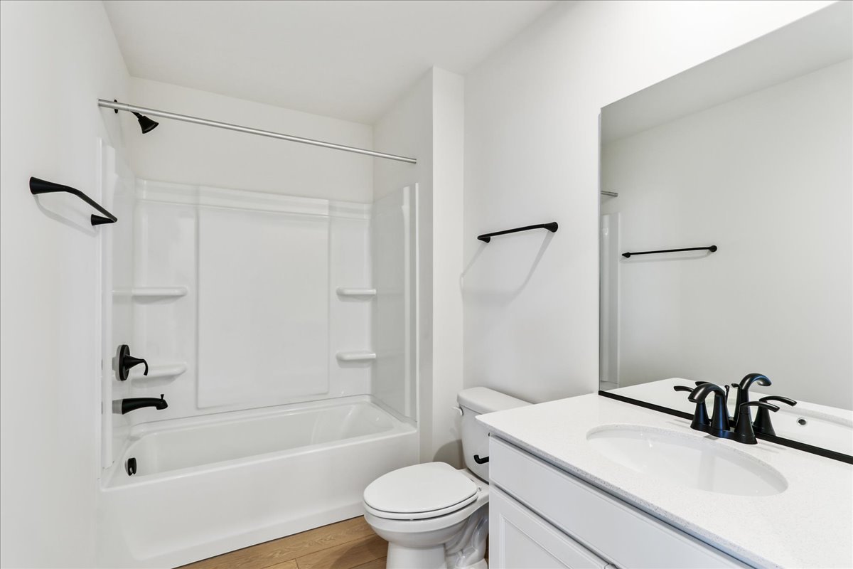 667 Switchgrass Way, Unit 62003 Bolingbrook, IL 60490 - Photo 28 of 33 a bathroom with a sink a toilet and a bathtub