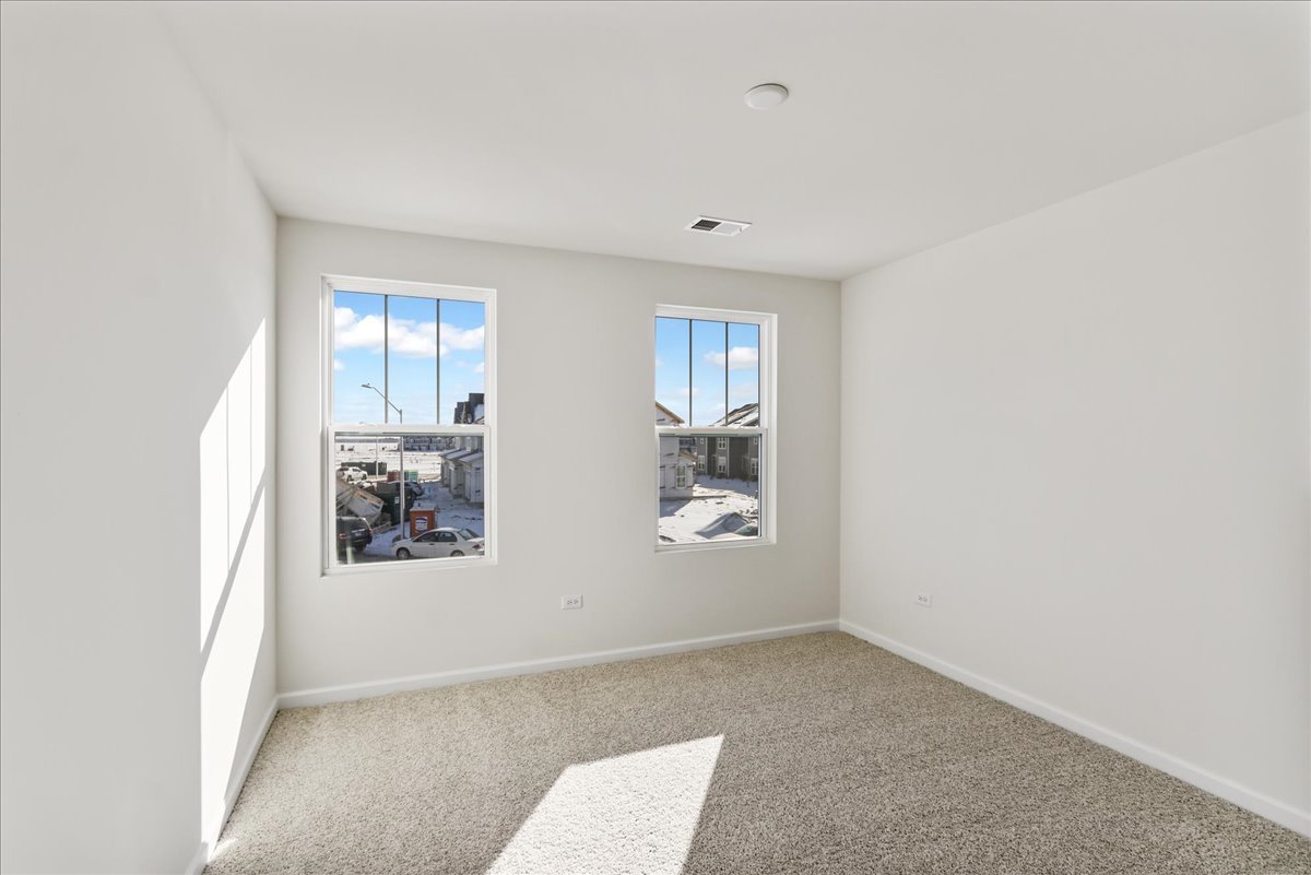 667 Switchgrass Way, Unit 62003 Bolingbrook, IL 60490 - Photo 29 of 33 an empty room with windows