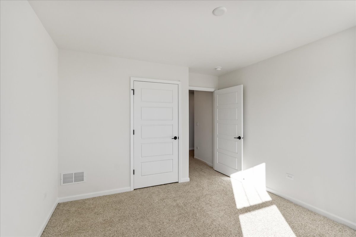 667 Switchgrass Way, Unit 62003 Bolingbrook, IL 60490 - Photo 30 of 33 a view of an empty room