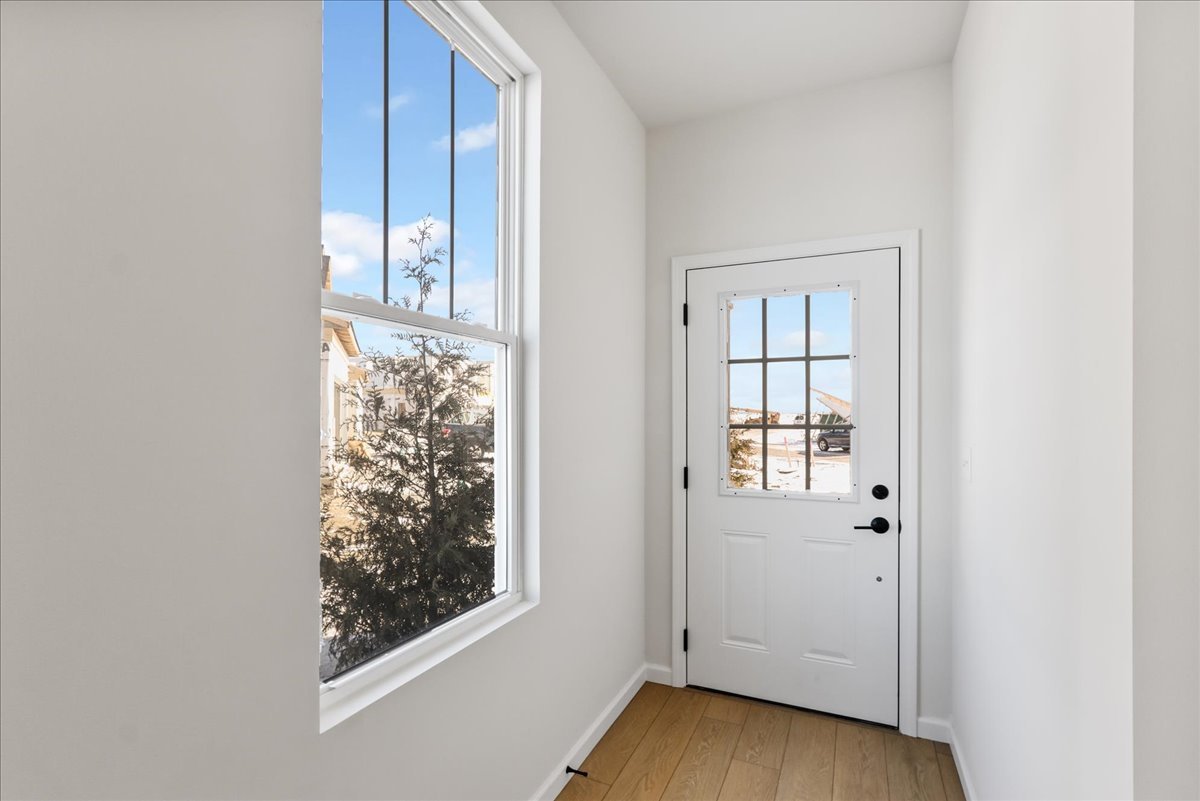 667 Switchgrass Way, Unit 62003 Bolingbrook, IL 60490 - Photo 3 of 33 an empty room with wooden floor closet and windows