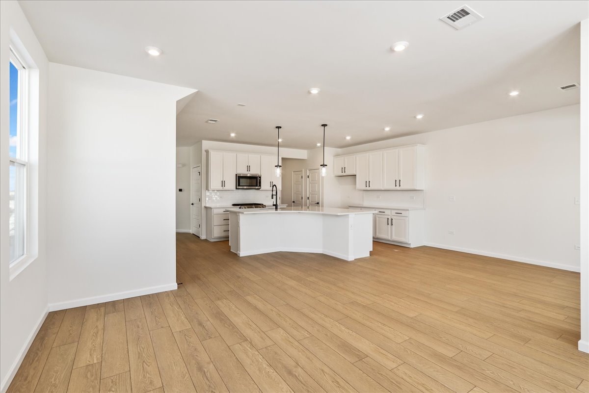 667 Switchgrass Way, Unit 62003 Bolingbrook, IL 60490 - Photo 10 of 33 a view of kitchen with wooden floor
