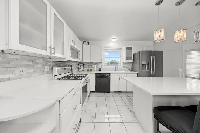 a kitchen with a white cabinets stove and refrigerator