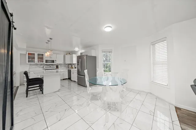 a view of kitchen with windows and refrigerator
