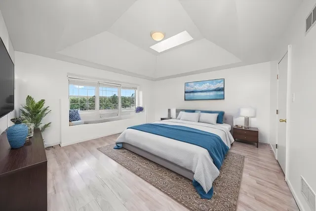 a bed room with a bed and a potted plant