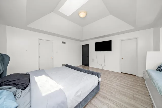 a bedroom with a bed and a television