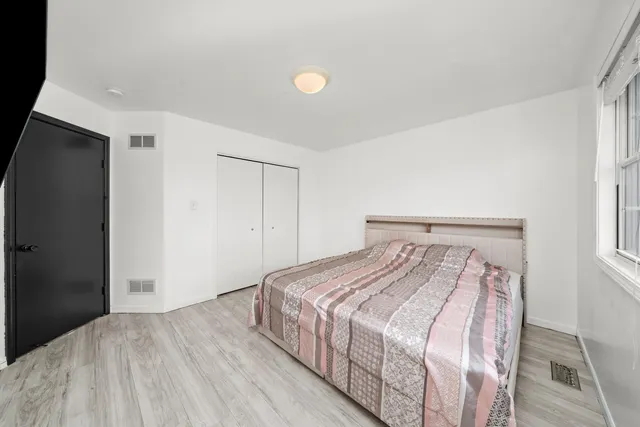 a bedroom with a bed and a window