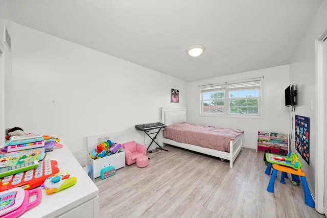 a bedroom with furniture and a wooden floor