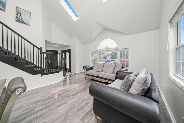a living room with furniture chess board and a window