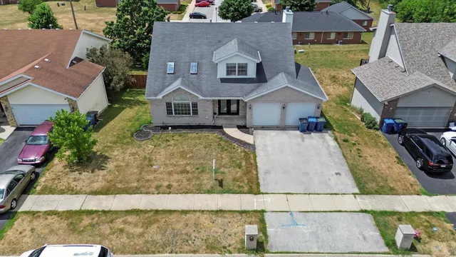 an aerial view of multiple houses with yard