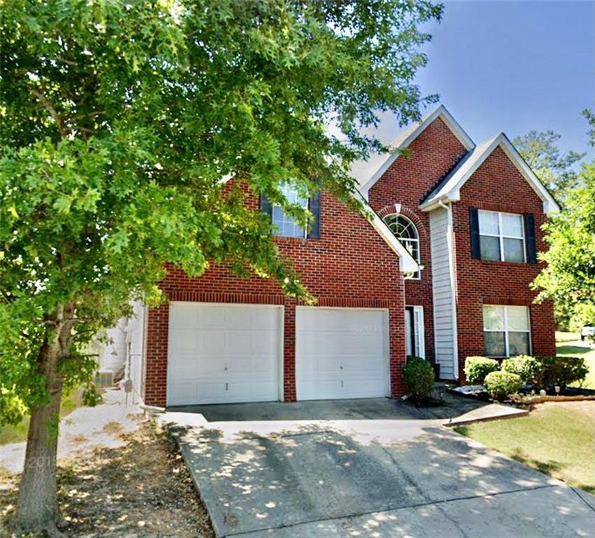 4221 Holliday Road Atlanta, GA 30349 - Photo 1 of 1 a front view of a house with a yard and garage
