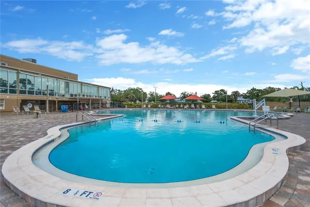 a view of a swimming pool with outdoor seating