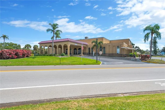 a view of a house with a swimming pool and a yard