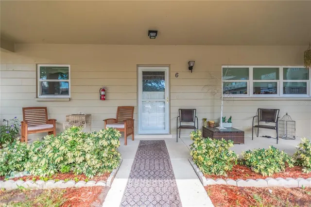 a view of a patio with table and chairs and potted plants