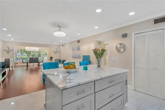 a kitchen with a sink dishwasher and a dining table with garden view