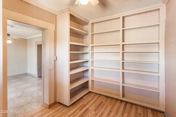 a view of walk in closet with empty racks