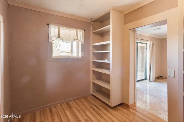a view of walk in closet with empty racks