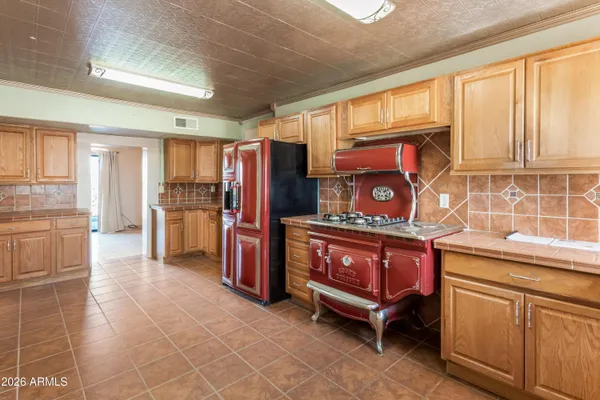 a kitchen with refrigerator cabinets and window