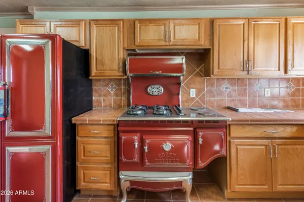 a stove top oven sitting inside of a kitchen