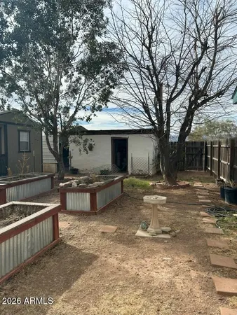 a view of a house with backyard and a tree