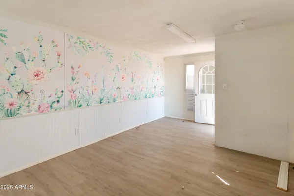 a view of a room with wooden floor and window