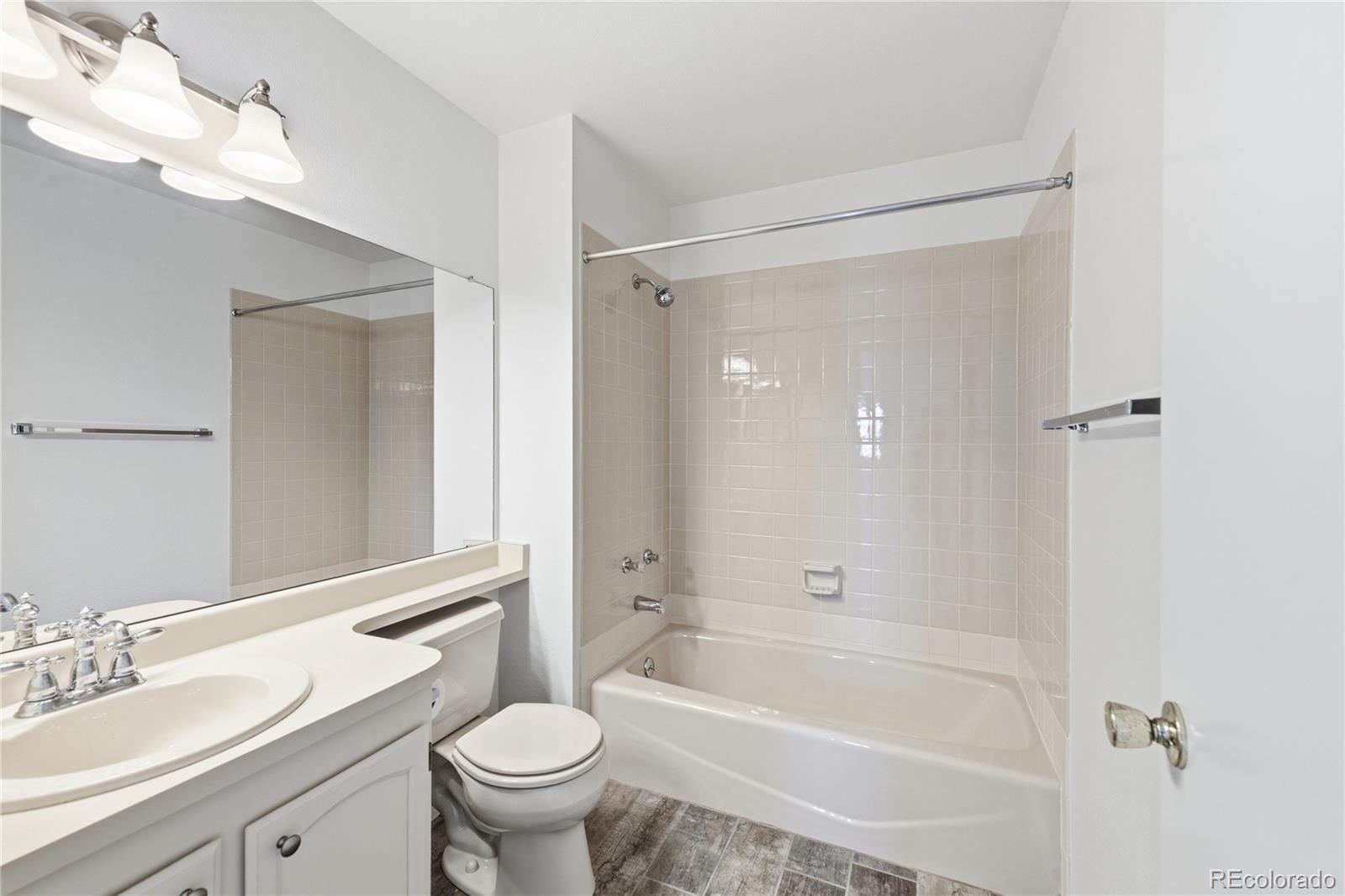 155 Blue Spruce Court Highlands Ranch, CO 80126 - Photo 21 of 29 a bathroom with a bathtub shower sink vanity mirror and toilet