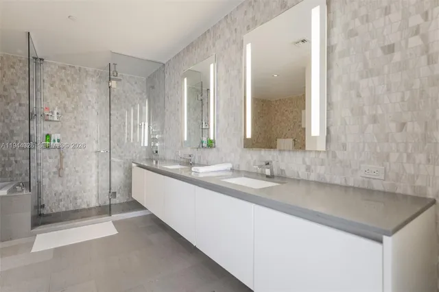 a large bathroom with a shower and a sink