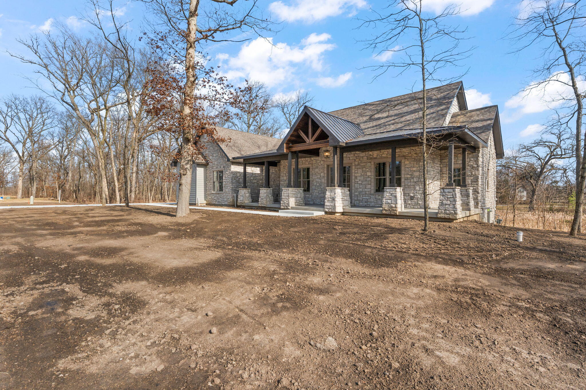 16669 Noble Street Lowell, IN 46356 - Photo 5 of 55 a front view of a house with a garden