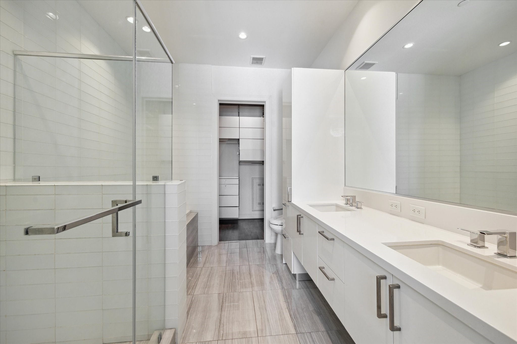1211 Caroline Street, Unit 1007 Houston, TX 77002 - Photo 13 of 46 a bathroom with a double vanity sink and mirror