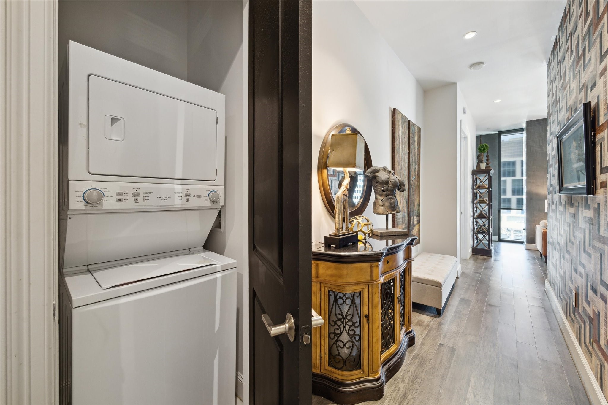 1211 Caroline Street, Unit 1007 Houston, TX 77002 - Photo 16 of 46 a view of a hallway with washer and dryer