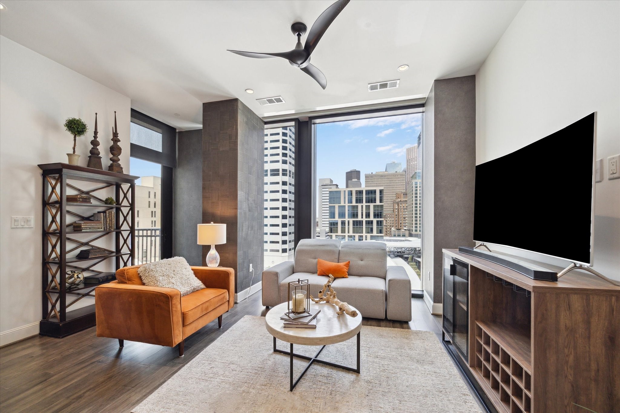 1211 Caroline Street, Unit 1007 Houston, TX 77002 - Photo 3 of 46 a living room with furniture and a flat screen tv