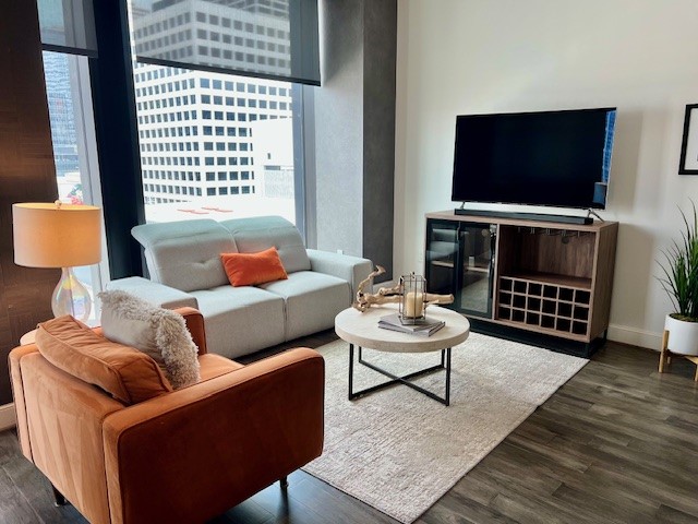 1211 Caroline Street, Unit 1007 Houston, TX 77002 - Photo 6 of 46 a living room with furniture and a flat screen tv